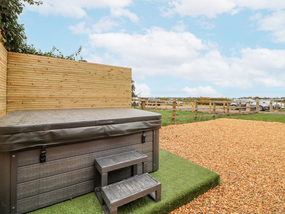 An outdoor area with a hot tub and steps at The House at School Farm in Hassall near Haslington