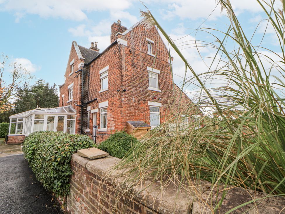 A house with a conservatory and garden area at The House at School Farm Hassall near Haslington