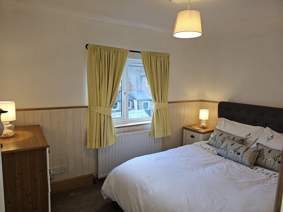 A bedroom with a bed and dresser at Twisted Chimney View in Alford