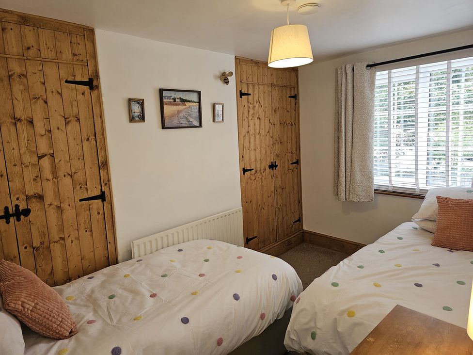 A bedroom with two beds and a window at Twisted Chimney View in Alford