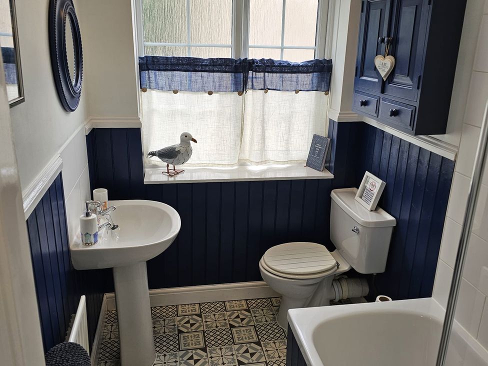A bathroom with a sink, toilet, and bathtub at Twisted Chimney View in Alford