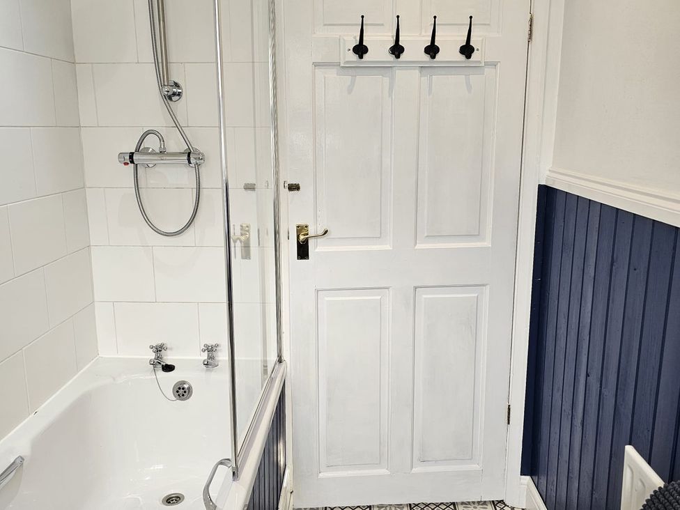 A bathroom with a bathtub and shower at Twisted Chimney View in Alford