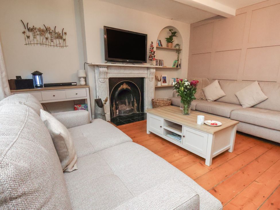 A living room with furniture and a television at Manor Farmhouse in Reighton near Filey
