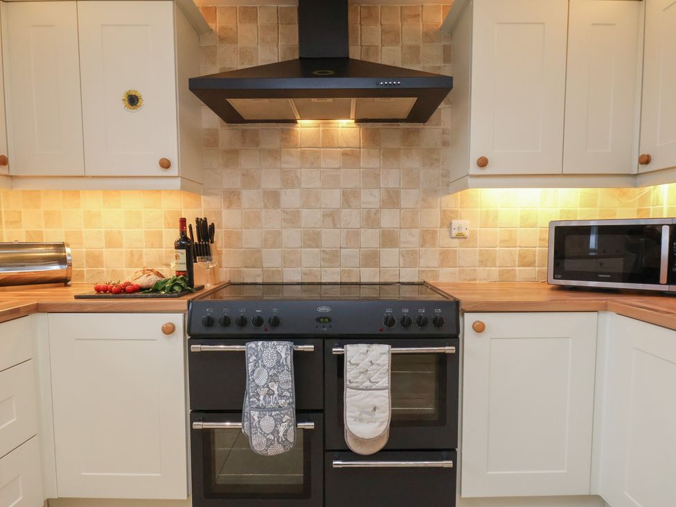 A kitchen with an oven and microwave at Manor Farmhouse in Reighton near Filey