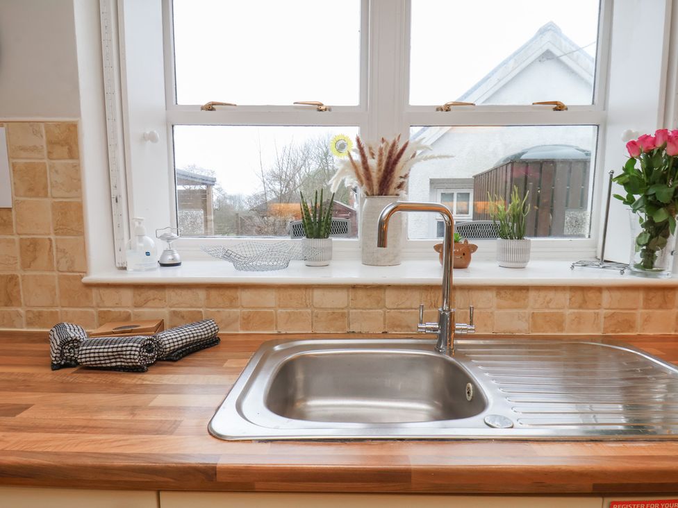 A kitchen with a sink under a window at Manor Farmhouse in Reighton near Filey