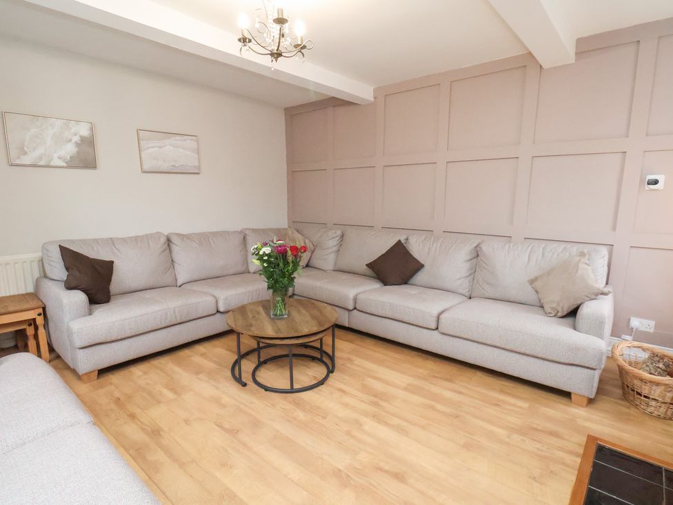 A living room with a sofa and coffee table at Manor Farmhouse in Reighton near Filey