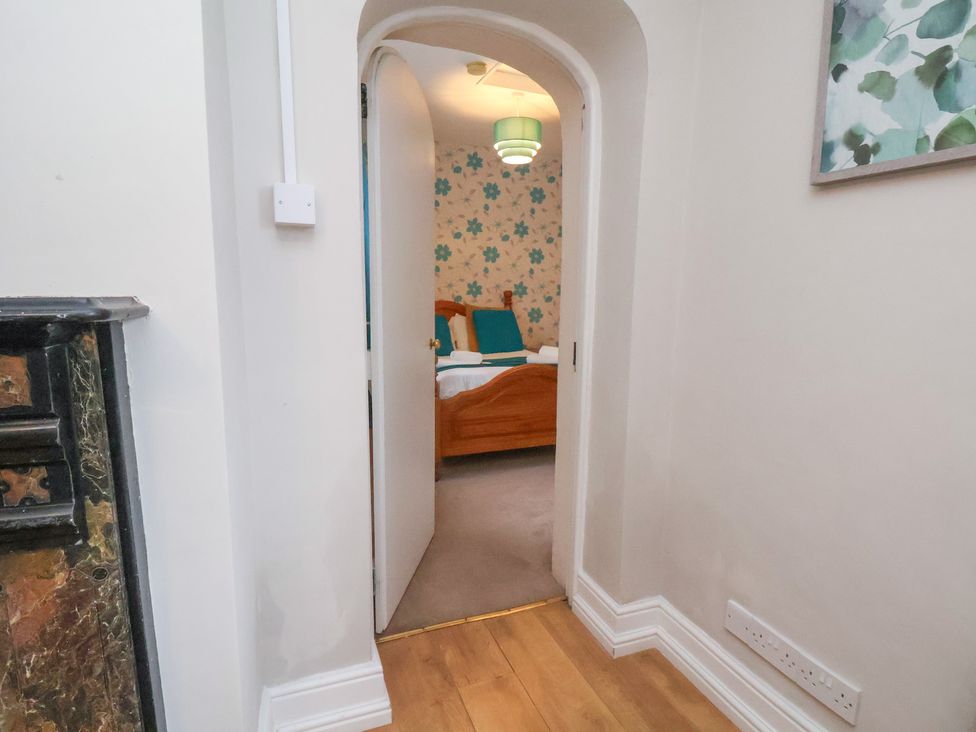 A view of a bedroom doorway and light fixture at Manor Farmhouse in Reighton near Filey
