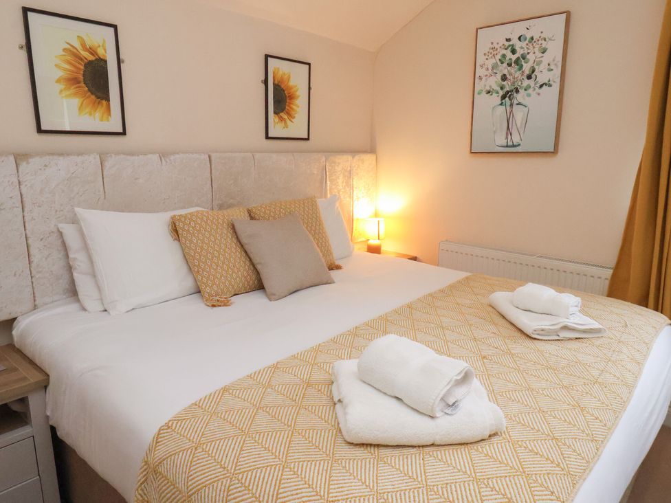 A bedroom with a bed and decorative items at Manor Farmhouse in Reighton near Filey