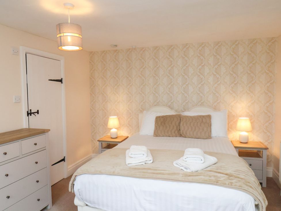 A bedroom with a double bed and bedside tables at Manor Farmhouse in Reighton near Filey
