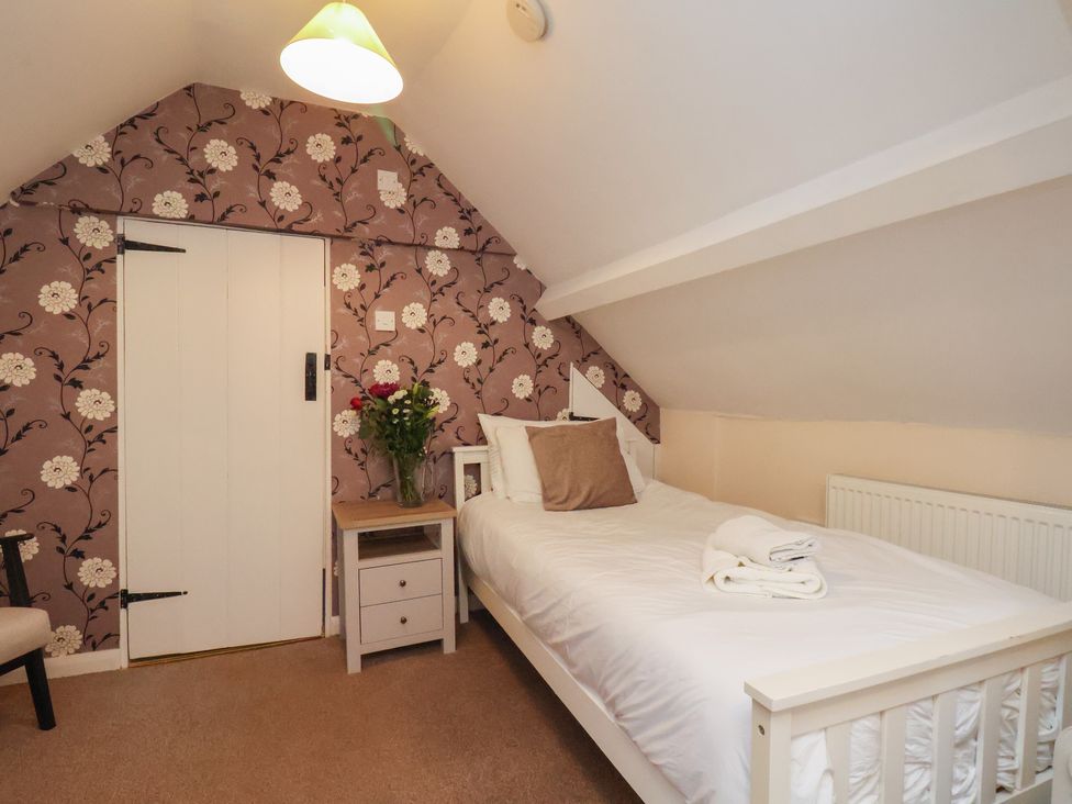 A bedroom with a bed and nightstand at Manor Farmhouse near Reighton Filey
