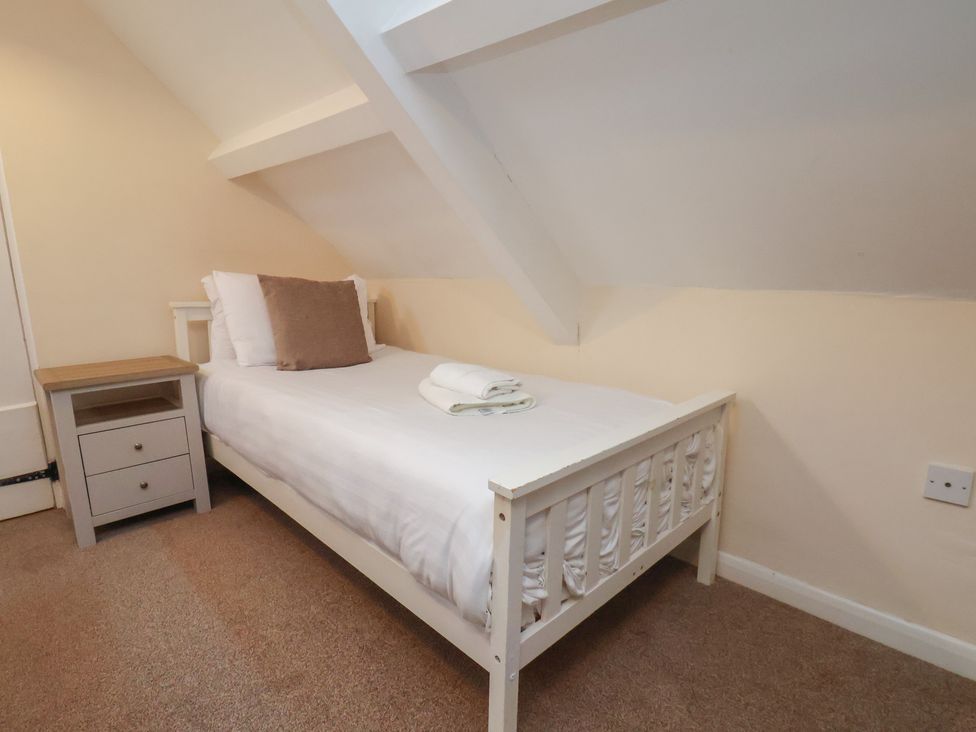 A bedroom with a single bed and bedside table at Manor Farmhouse in Reighton near Filey