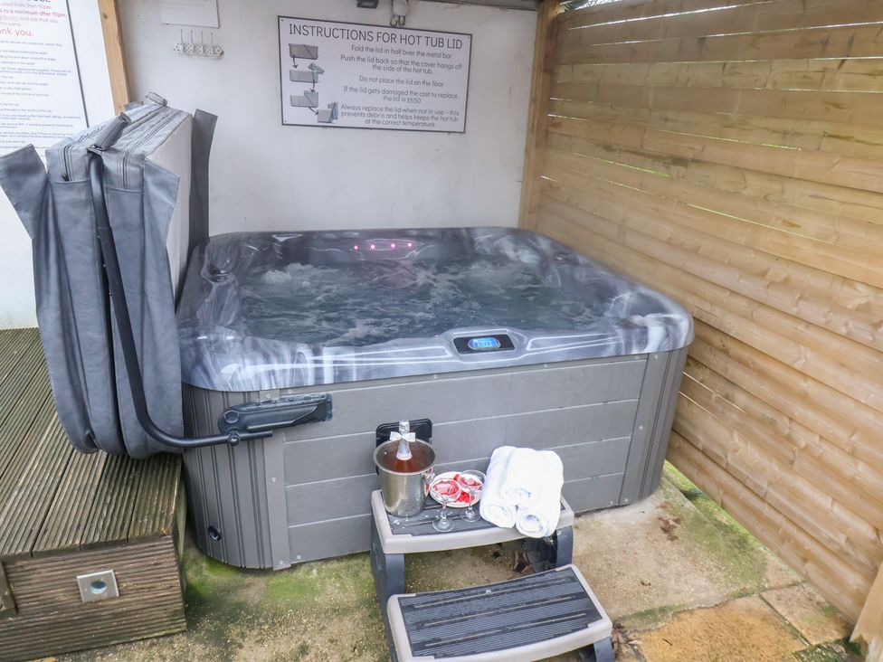 A hot tub and seating area at Manor Farmhouse in Reighton near Filey