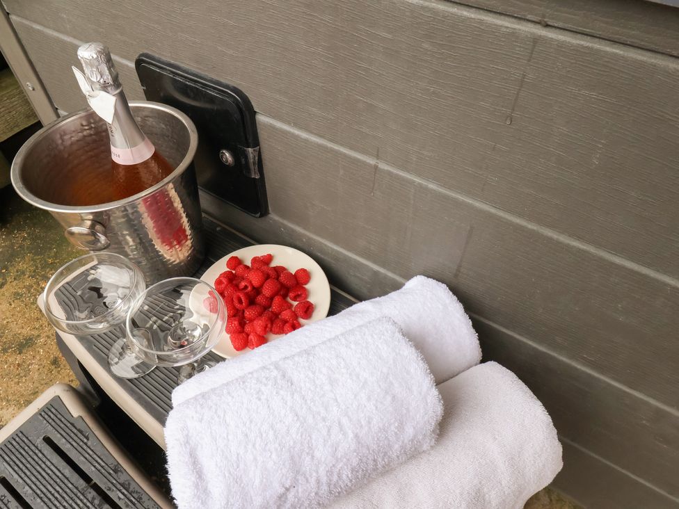 An ice bucket with wine, glasses, raspberries, and towels at Manor Farmhouse in Reighton near Filey