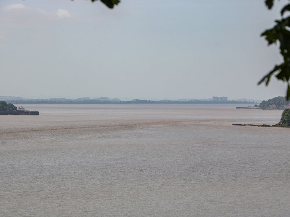 A river landscape with distant buildings at Anvil Cottage in Gatcombe near Blakeney