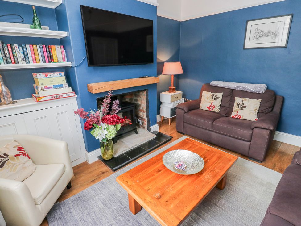 A living room with a television and a fireplace at 49 Waddington Road in Clitheroe