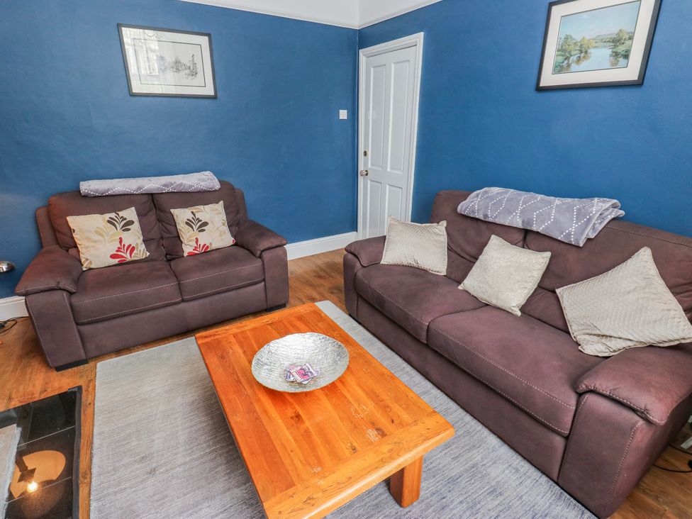 A living room with two sofas and a wooden coffee table at 49 Waddington Road in Clitheroe