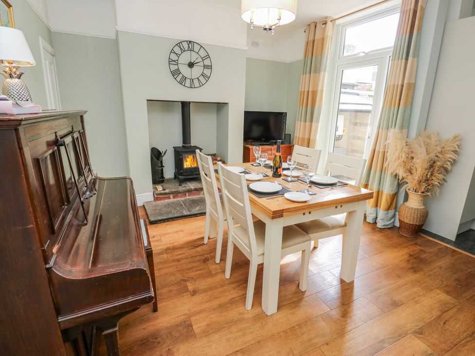 A dining room with a table, chairs, and a fireplace at 49 Waddington Road Clitheroe