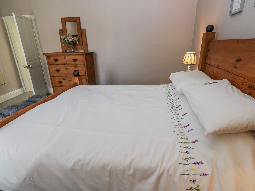 A bedroom with a bed and dresser at 49 Waddington Road in Clitheroe