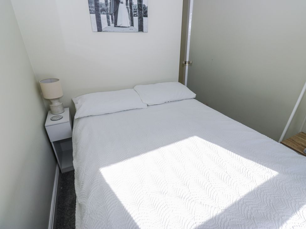 A bedroom with a bed and lamp at 49 Waddington Road, Clitheroe