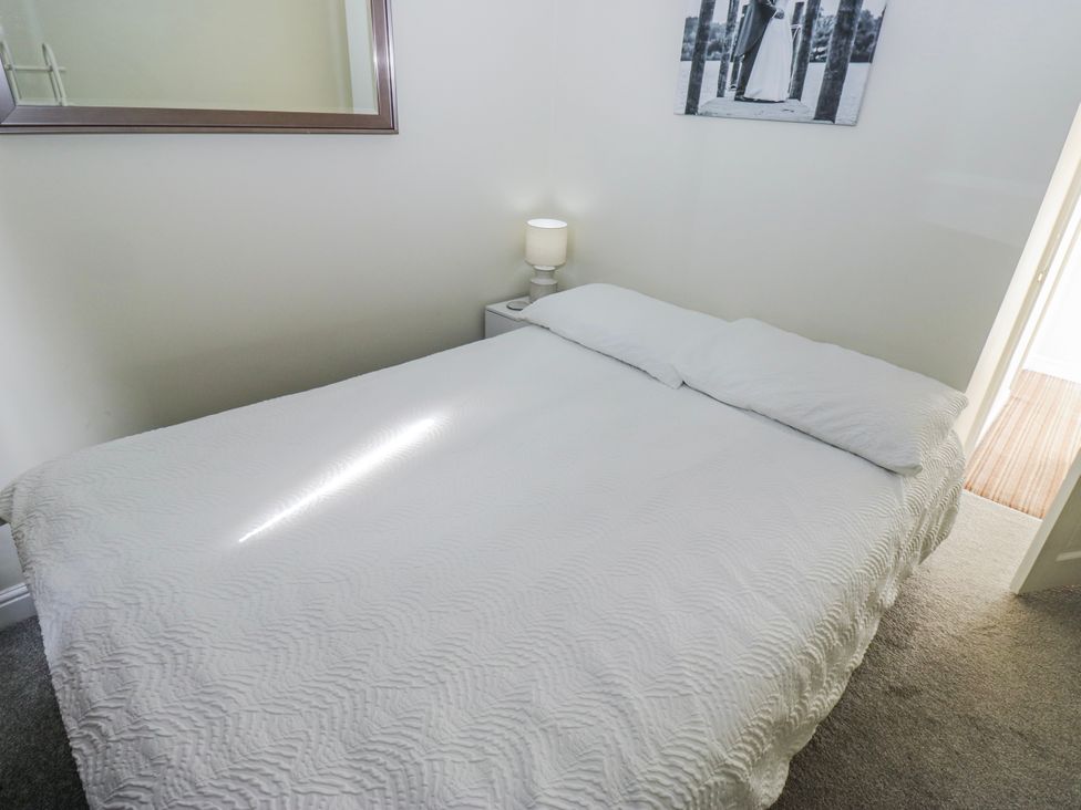 A bedroom with a bed and a lamp at 49 Waddington Road Clitheroe