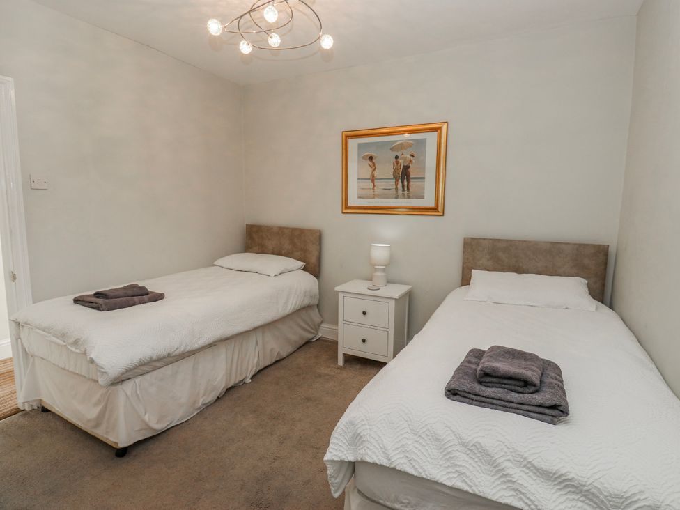 A bedroom with two beds and a bedside table at 49 Waddington Road Clitheroe