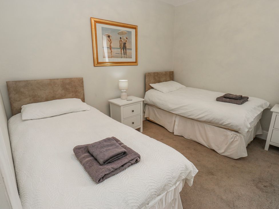 A bedroom with two single beds and a nightstand at 49 Waddington Road in Clitheroe