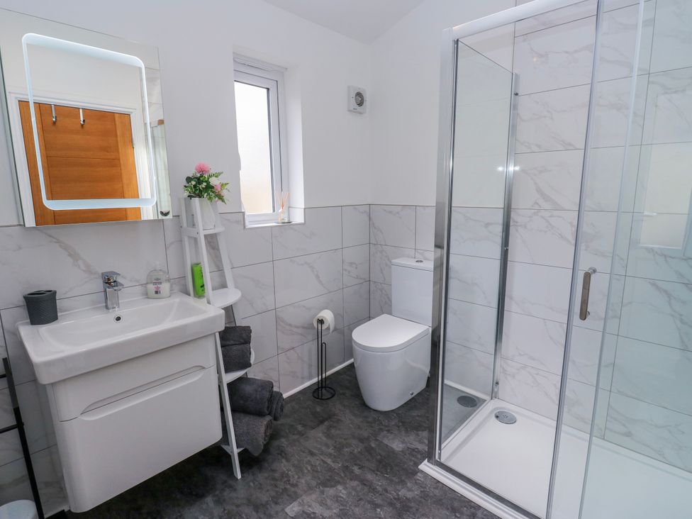 A bathroom with a sink, shower, and toilet at 49 Waddington Road Clitheroe
