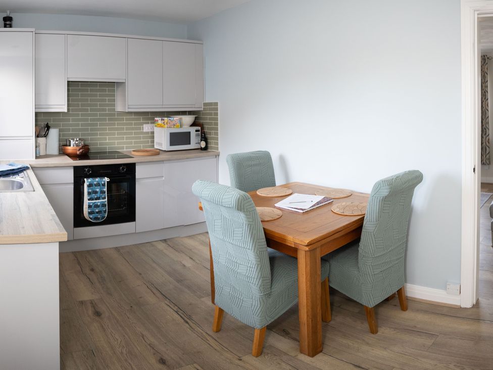 A kitchen with a dining area featuring a table and chairs at Deer Hill Grove in York