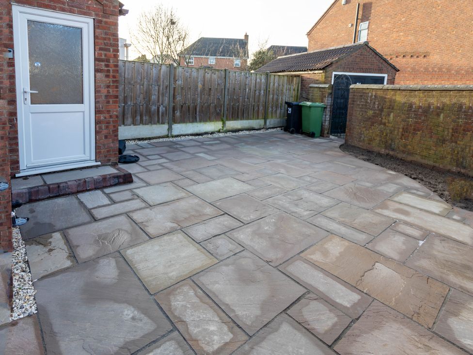 A garden area with paving stones and a door at Deer Hill Grove in York