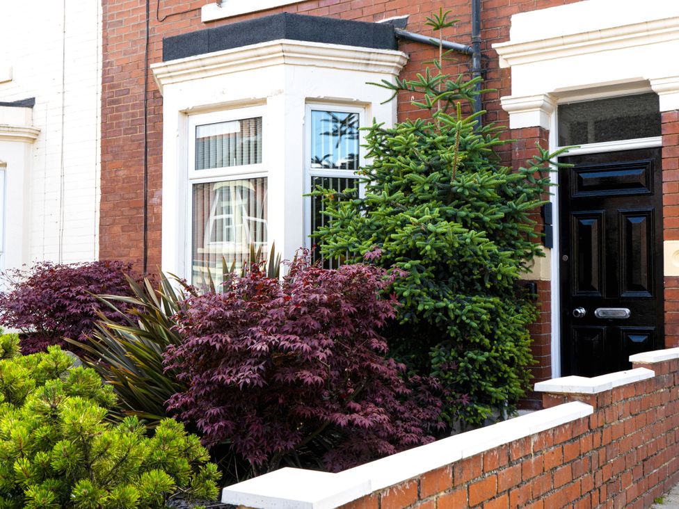 A front garden with a door and window at The George in Whitley Bay