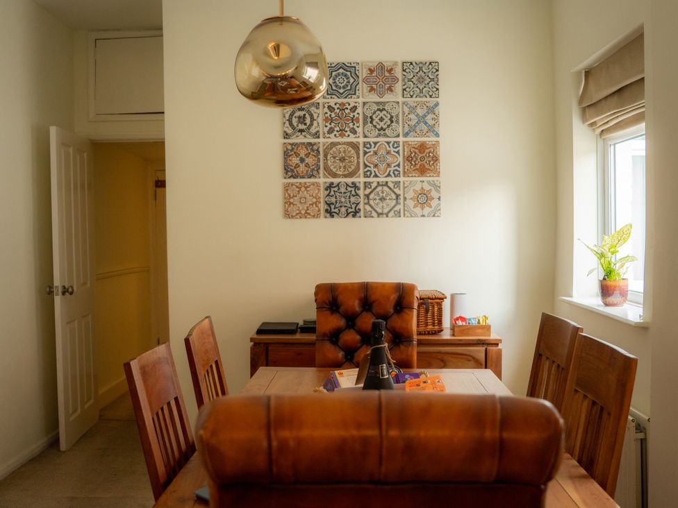 A dining room with a table and chairs at The George in Whitley Bay