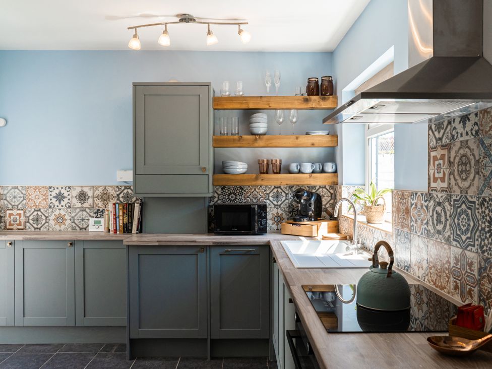 A kitchen with cabinets and appliances at The George in Whitley Bay