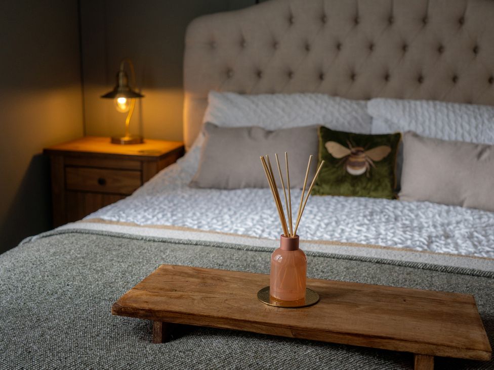 A bedroom with a bed and bedside table at The George in Whitley Bay