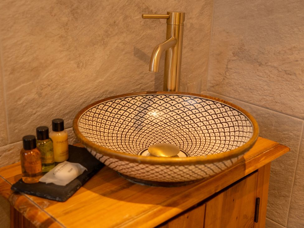 A wash basin with a faucet and toiletries at The George in Whitley Bay
