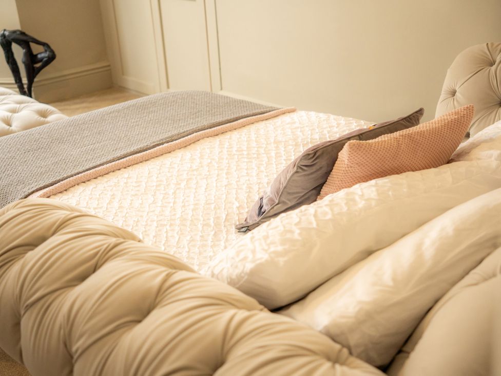 A bedroom with a bed and pillows at The George in Whitley Bay