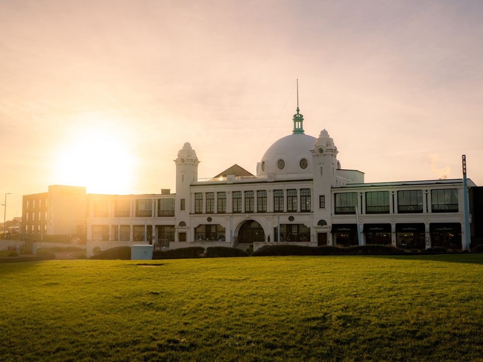 A building with a dome and green detailing at The George in Whitley Bay