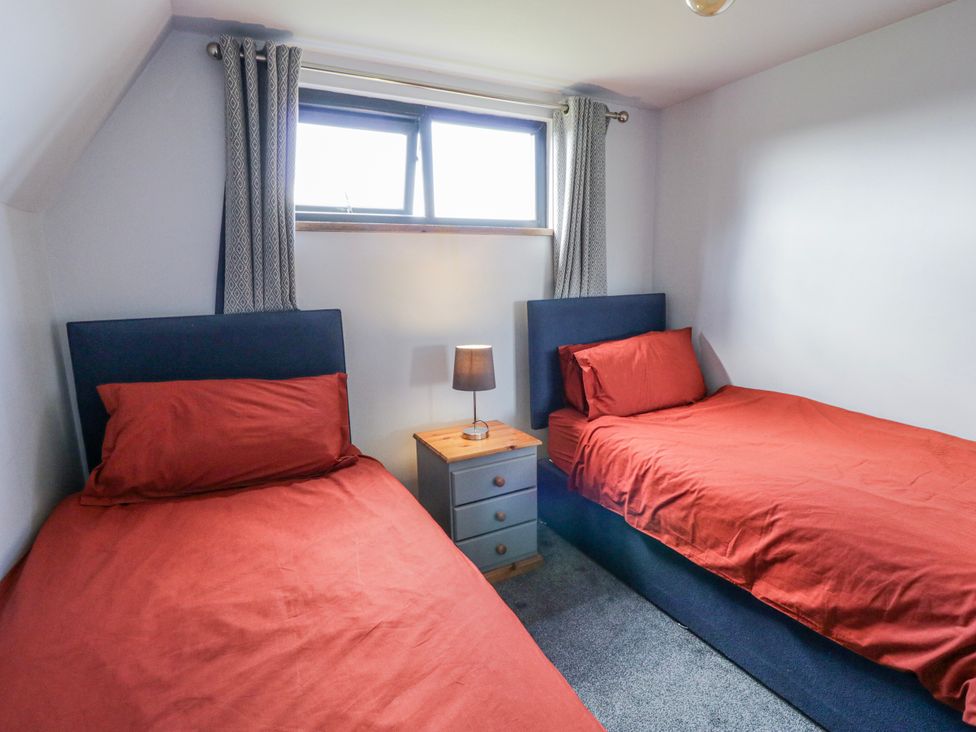 A bedroom with two beds and a nightstand at Valley View Hideaway in Ffostrasol