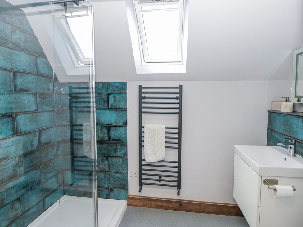 A bathroom with a shower and sink at Valley View Hideaway in Ffostrasol