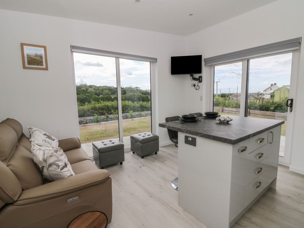 A living room with a sofa and table at Rydlan in Aberystwyth