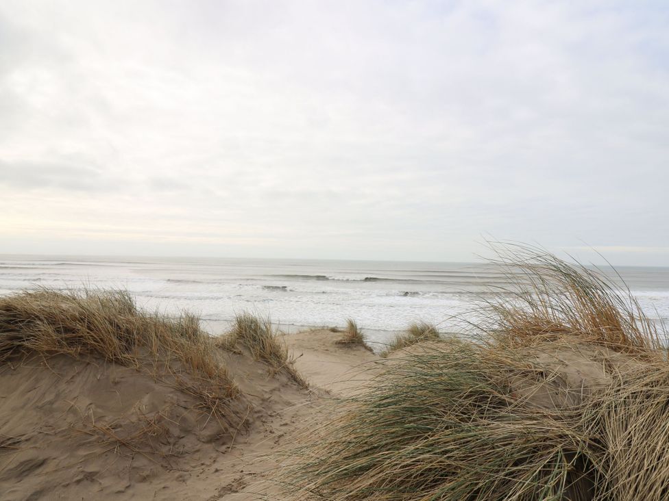 A view of ocean waves and sand dunes near the beach at Rydlan Near Borth