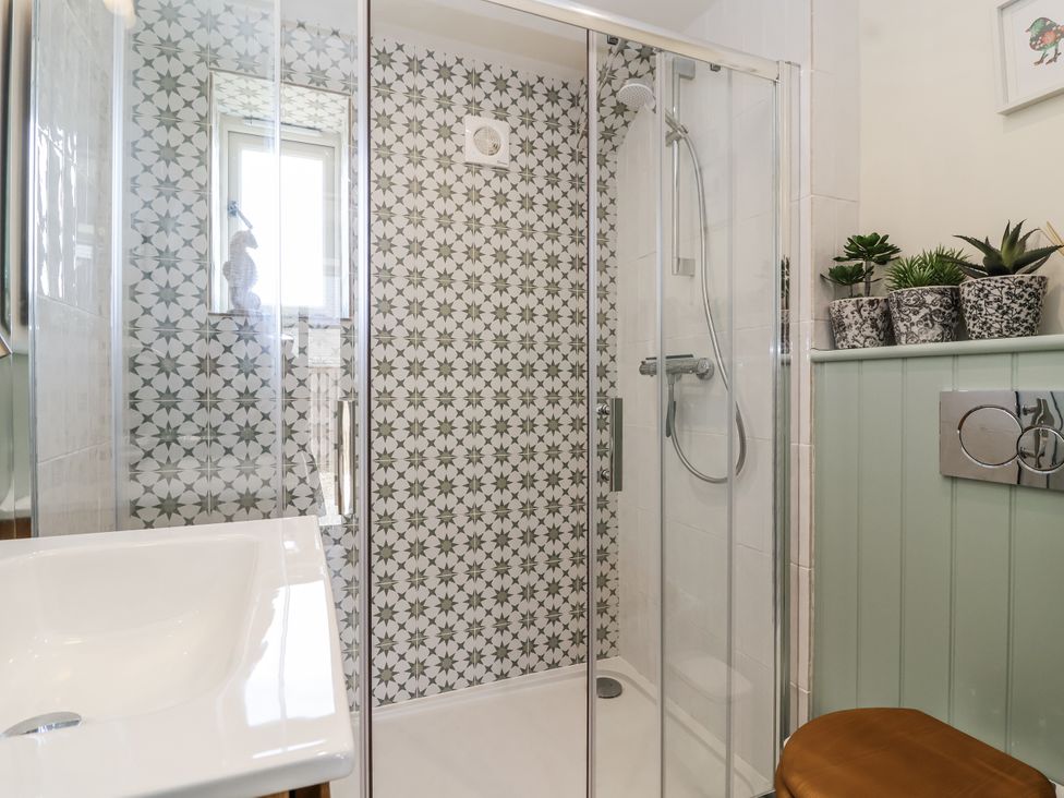 A bathroom with a shower and sink at The Little Loft in Burford