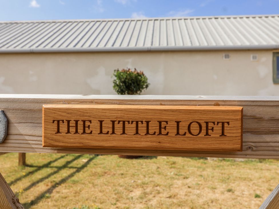 A wooden sign with the name The Little Loft at The Little Loft in Burford