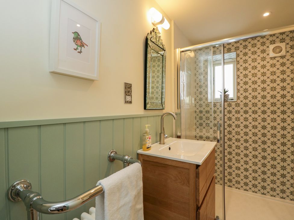 A bathroom with a shower and sink at The Little Loft in Burford