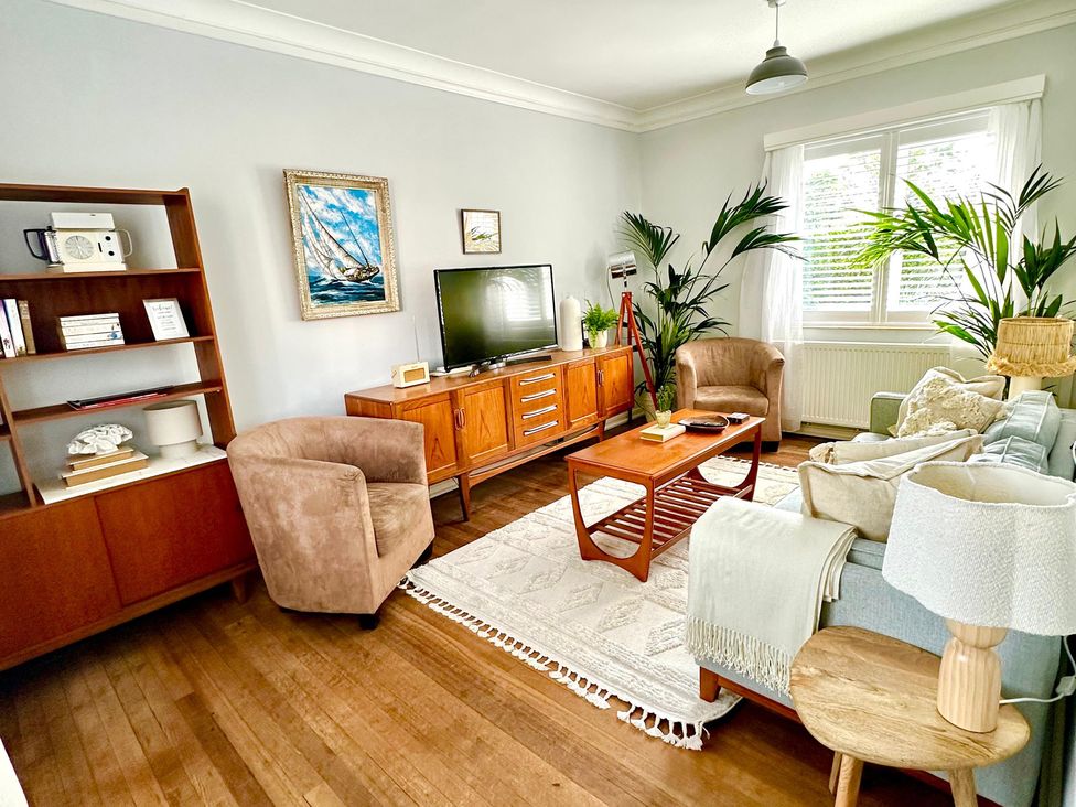 A living room with a coffee table and television at The Shingles in Sandown