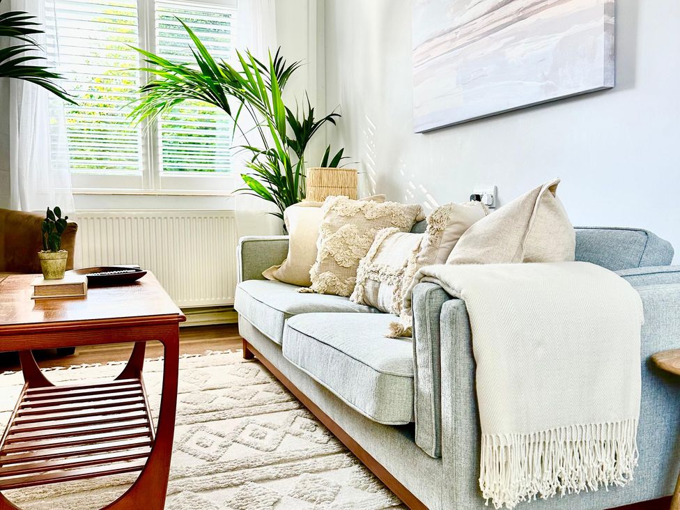 A living room with a sofa and coffee table at The Shingles in Sandown