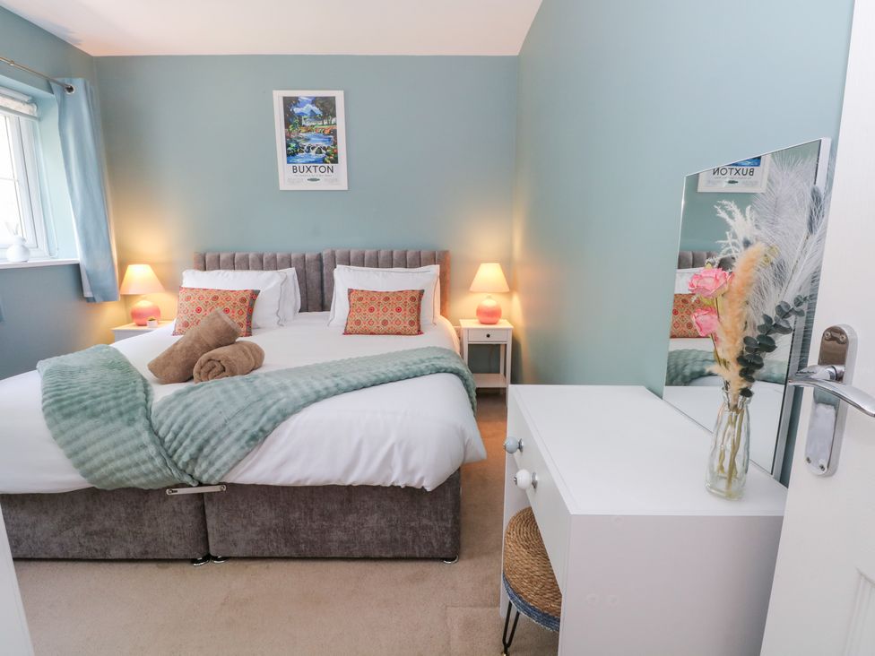 A bedroom with a bed and bedside table at Woodland View in Buxton