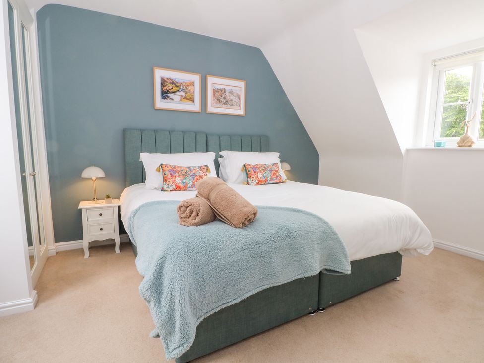 A bedroom with a bed and bedside table at Woodland View Buxton