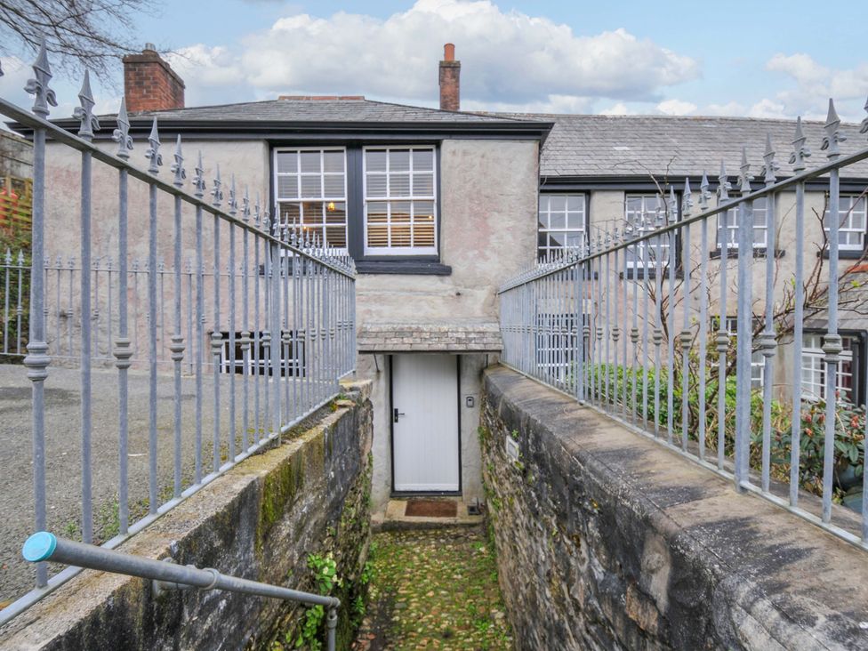 An outdoor entrance with a door and stone steps at Jolly Crabber in Porthpean near St Austell