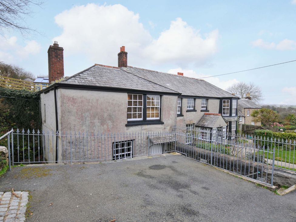 An exterior view of a house with a driveway and garden at Jolly Crabber Porthpean near St Austell