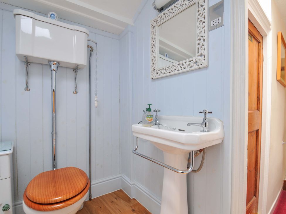 A bathroom with a toilet and sink at Smugglers in Porthpean near St Austell